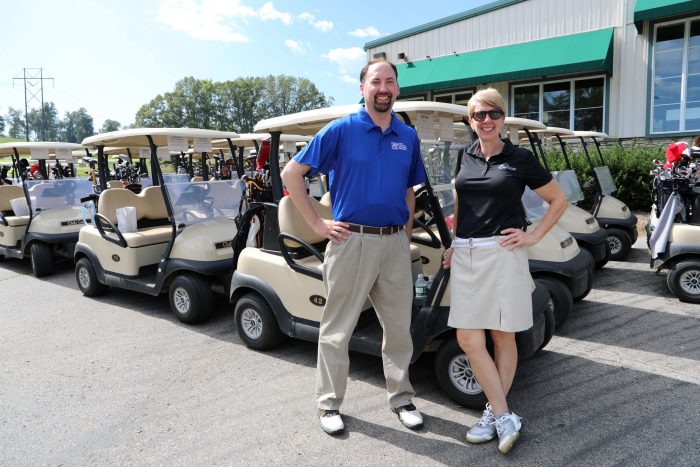 Golfers in front of golf carts