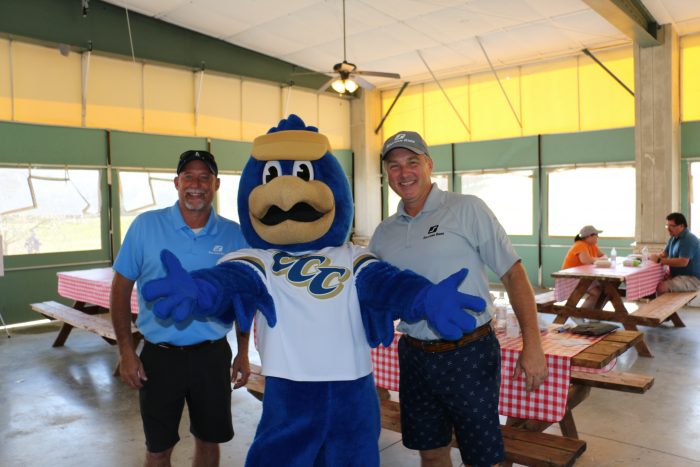 Franklin the Falcon posing with golfers