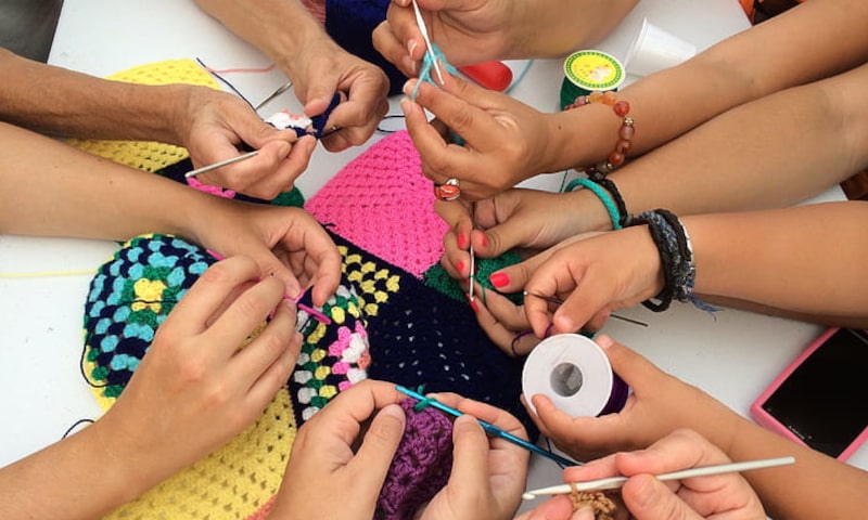 Overhead shot of hands working with yarn