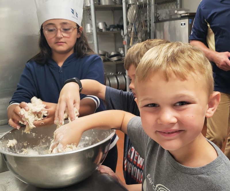 Students making pizza dough