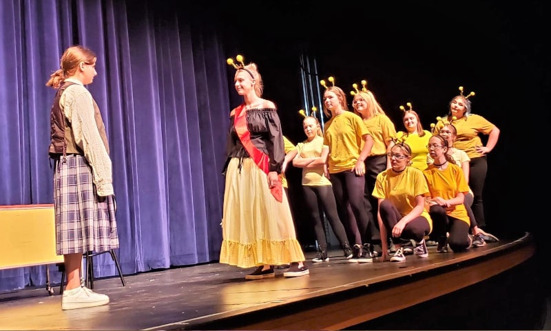 Teenagers acting in play on stage