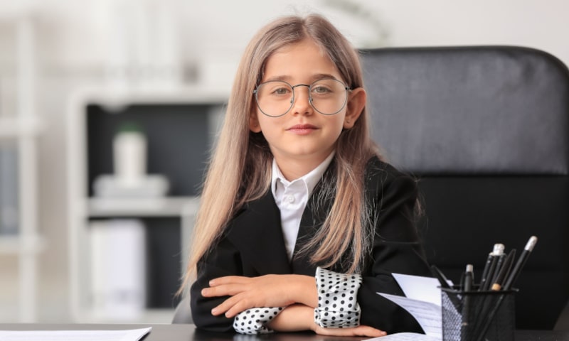 Girl in business attire sitting at a desk