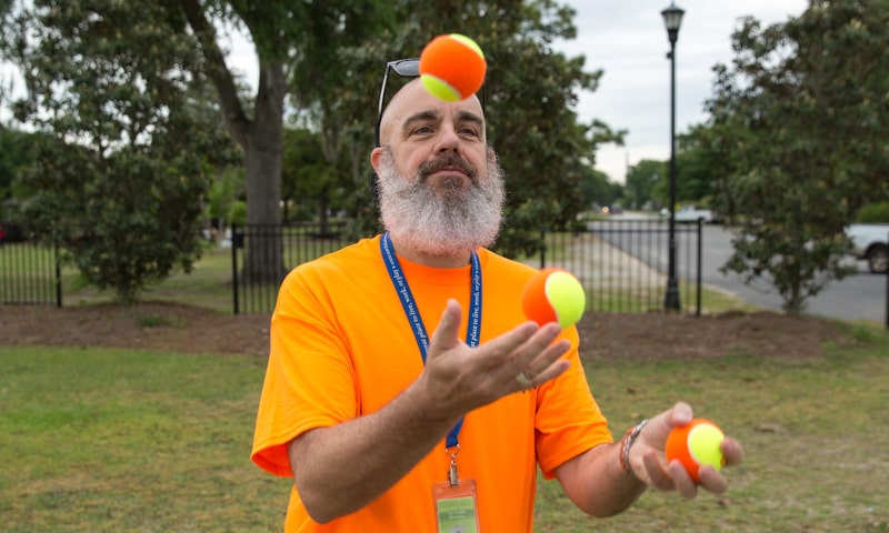 Bearded man juggling balls