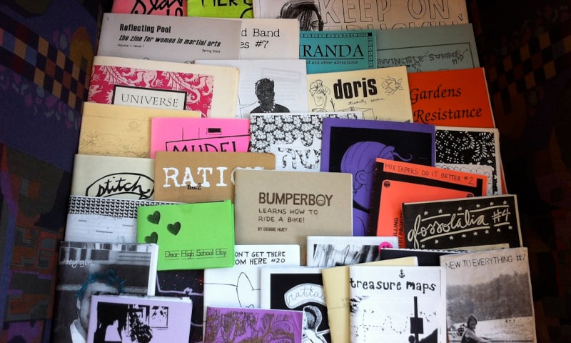 A stack of different custom-made zines