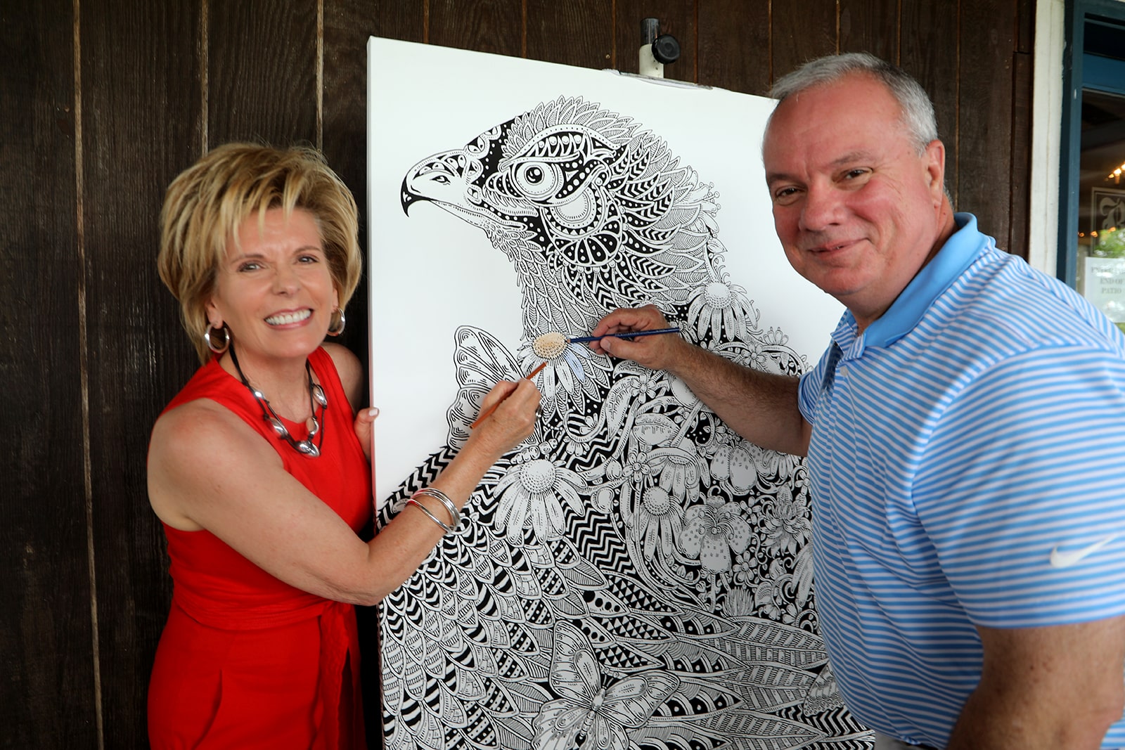 Dr. Bauer smiling with art work