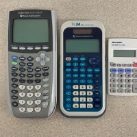 Three calculator laying on table