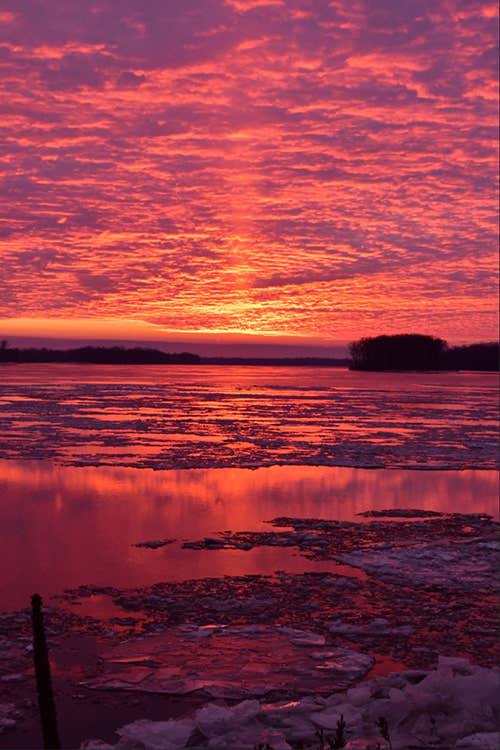 Sun Pillar at Sunset Over the Mississippi by Kevin Dixon