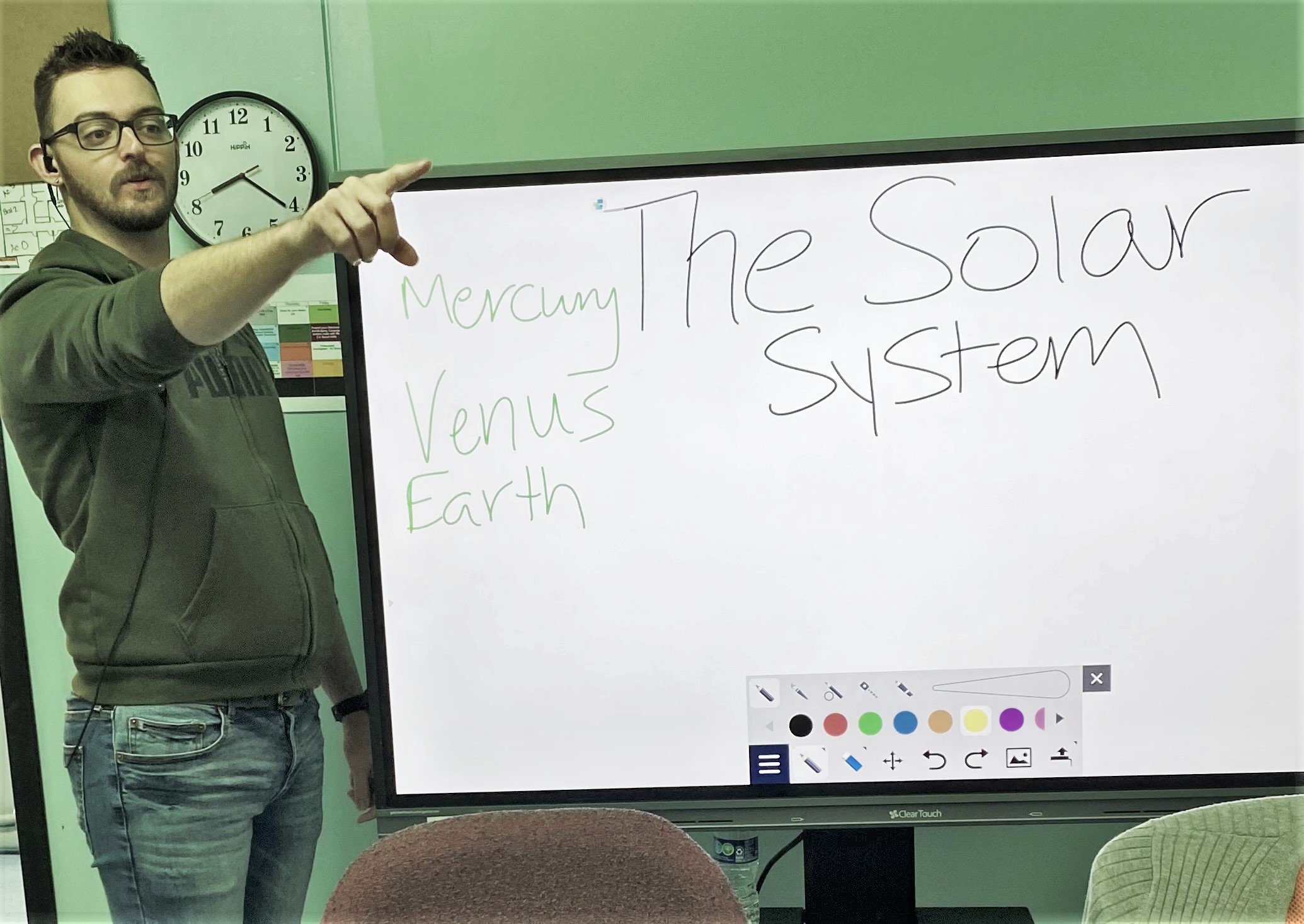 Austin Gildehaus in front of whiteboard in class