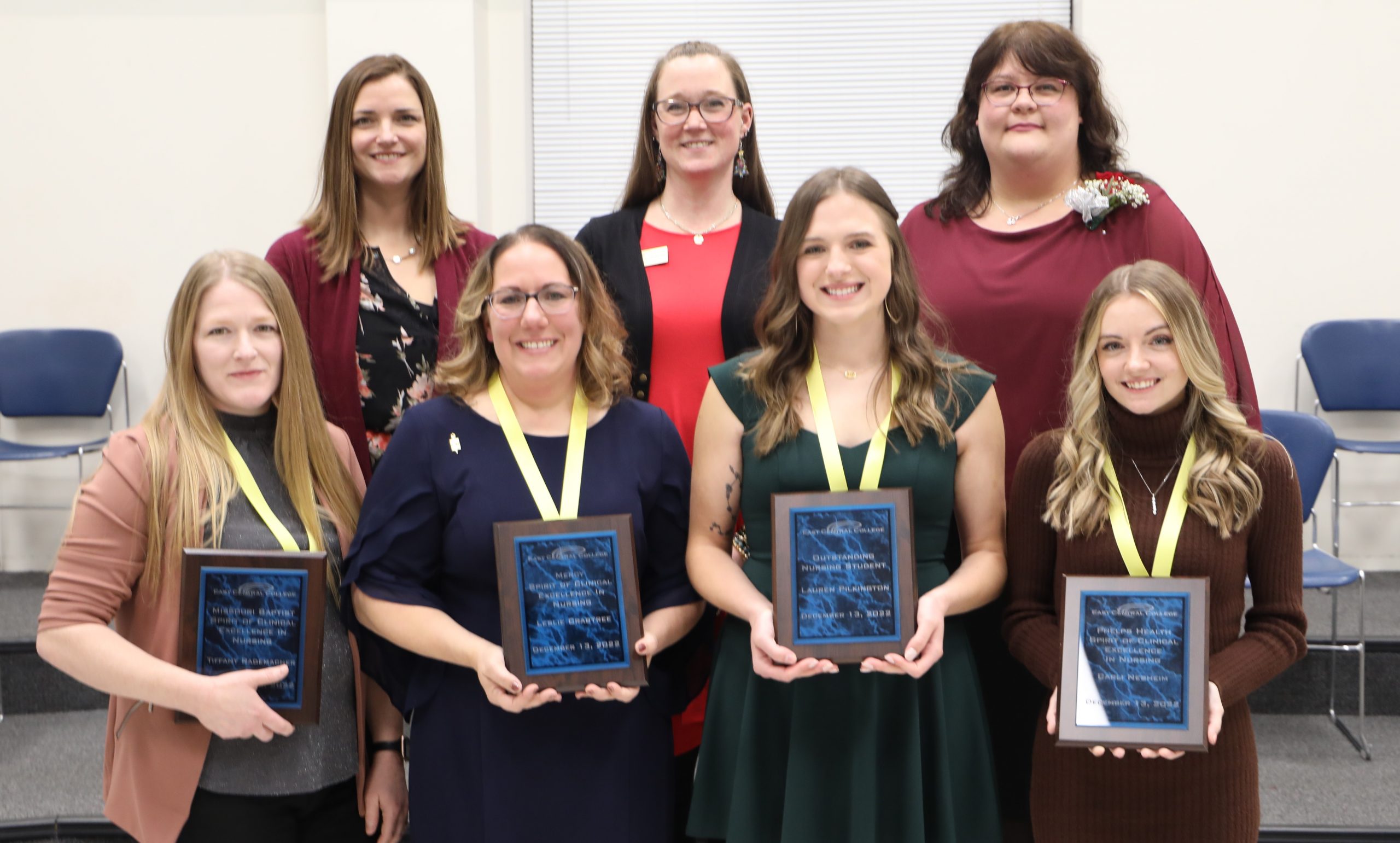Nursing instructors posing with plaques.