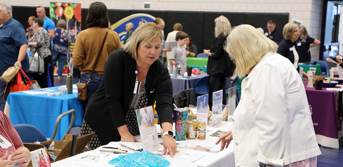 Senior woman at vendor display at Senior Expo