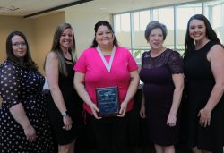ECC instructors posing for photo with outstanding nursing student