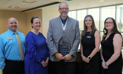 ECC instructors posing for photo with nursing student