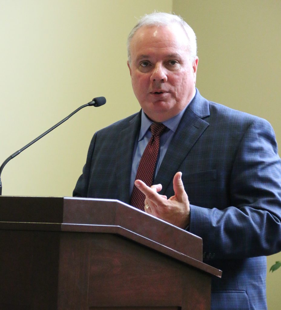 Dr.Bauer speaking at podium