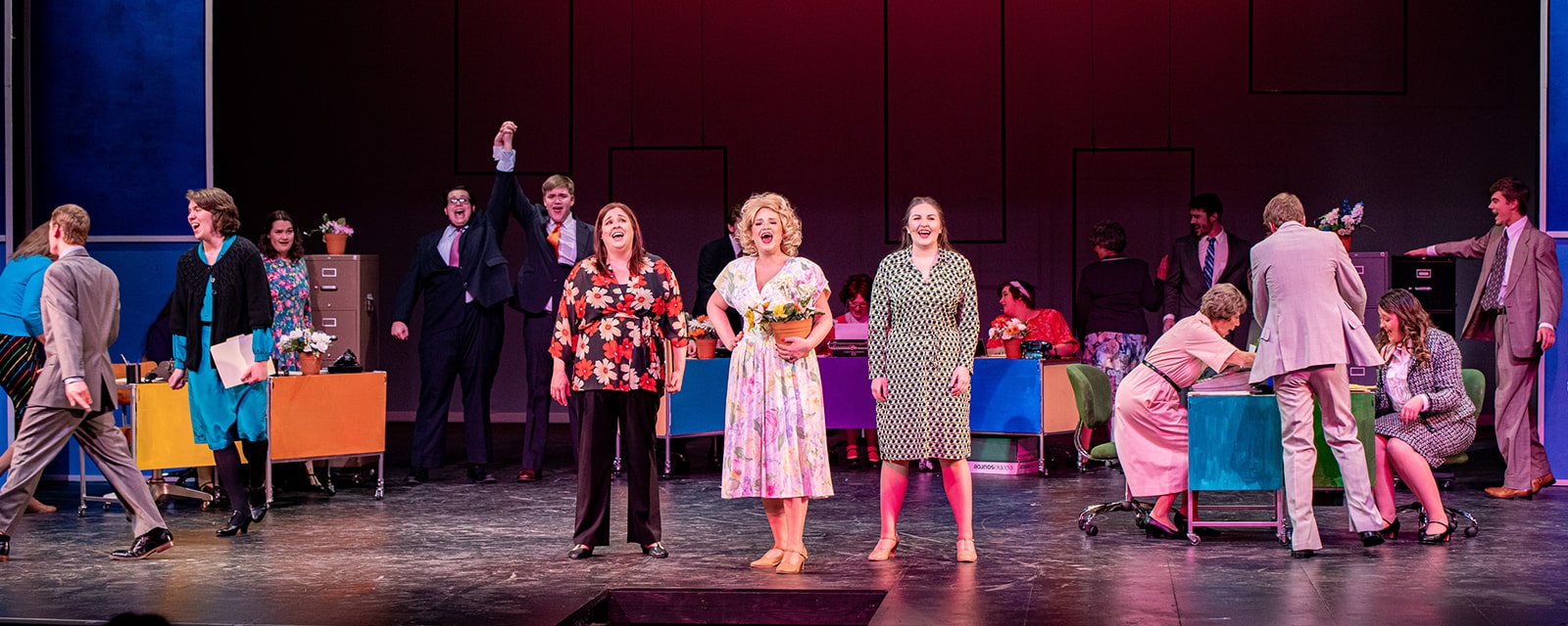 Actors performing on stage for 9 to 5 musical