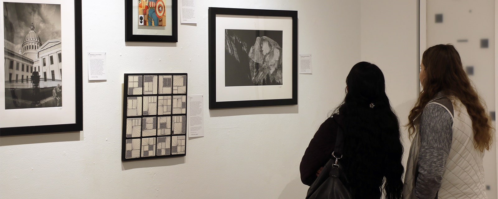 Students viewing painting in art gallery