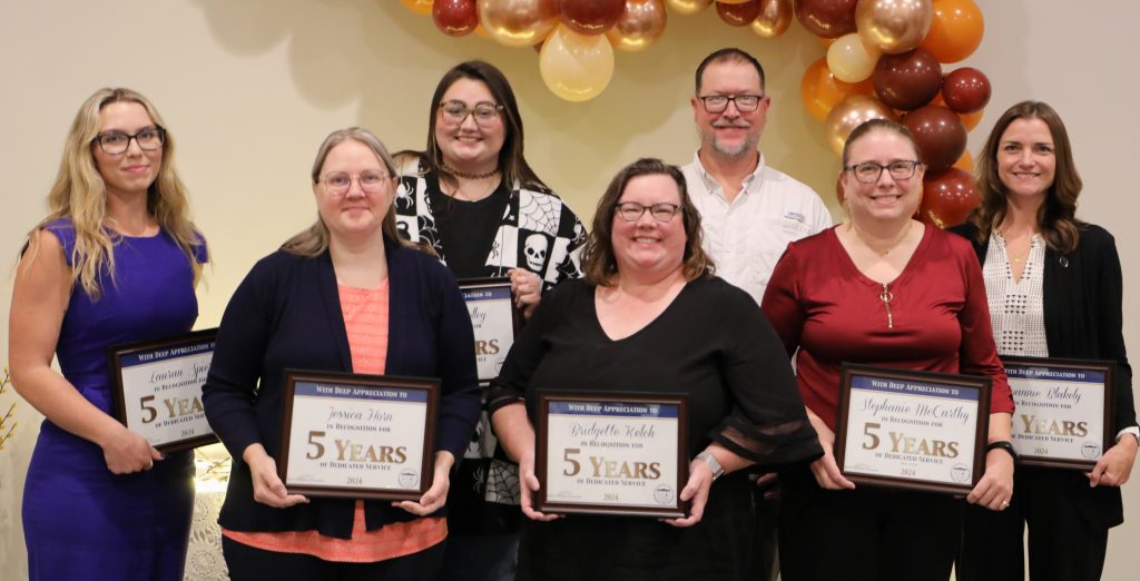 Seven ECC employees holding certificates for 5 years of service, 