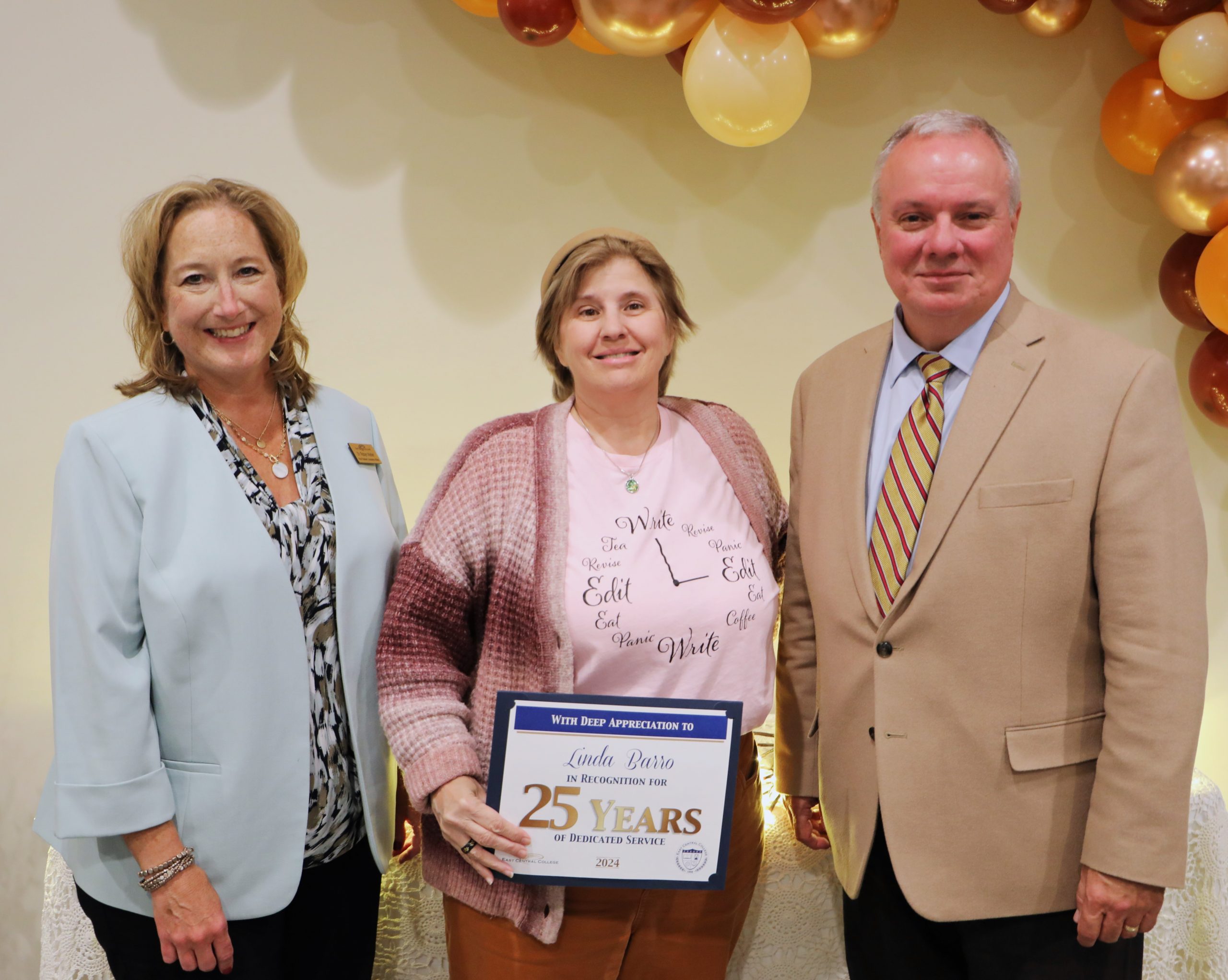 Pictured, are two ECC administrators and an instructor who is holding a 25-years of service award.