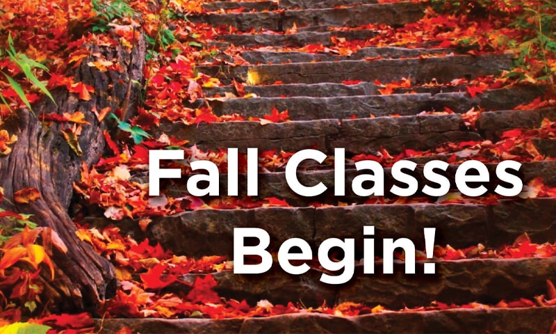 Autumn leaves on stone stairs with the text Fall Classes Begin