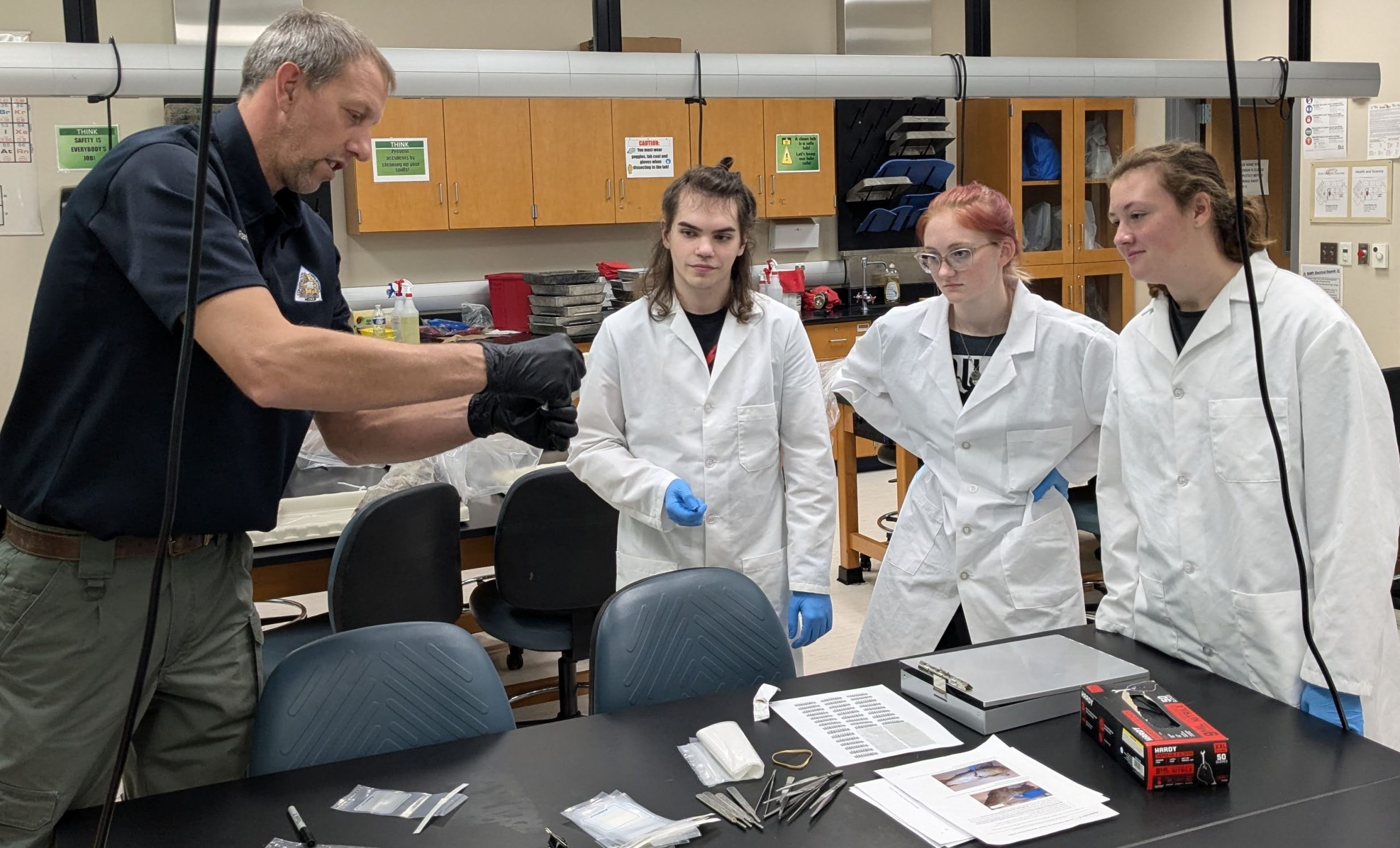 Biologist Raenhard Wesselschmidt and students in biology lab