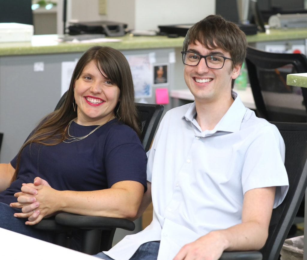 Claire and Eric smiling and holding hands in the Learning Center