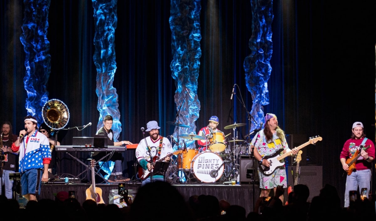 The Mighty Pines performing on stage at night