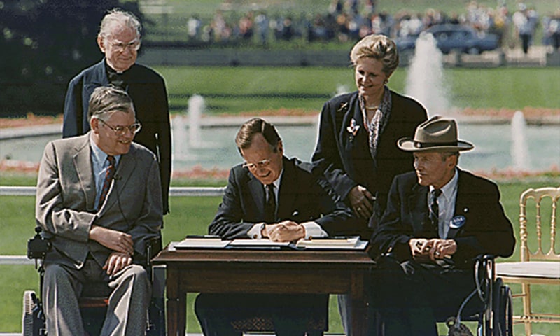 President George H. W. Bush sign the Americans with Disabilities Act